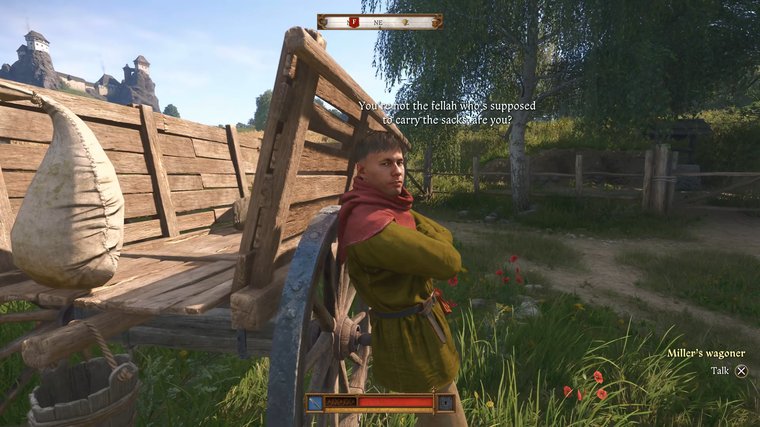 Kingdom Come: Deliverance II Miller's wagoner leaning against a wagon and speaking.