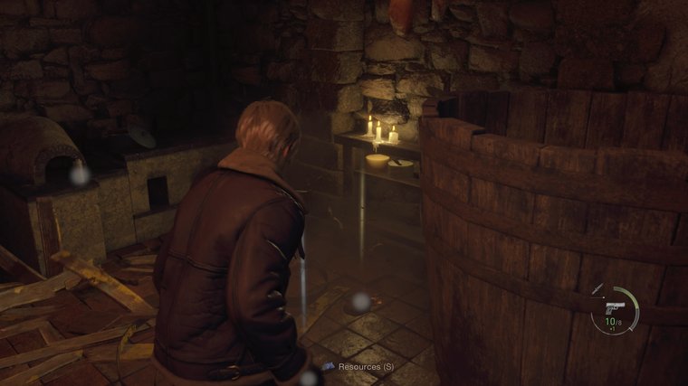 Resident Evil 4 - Protagonist finding some resources on the ground from destroying a barrel.