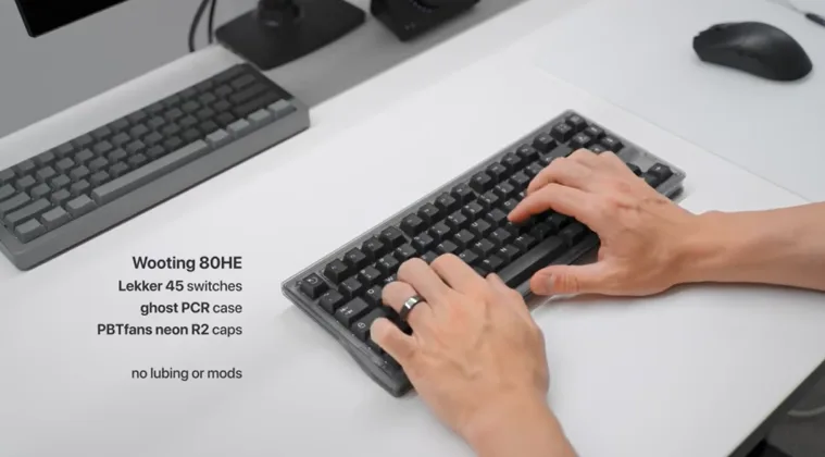 A keyboard on a table with a person typing, accompanied by the product name and description