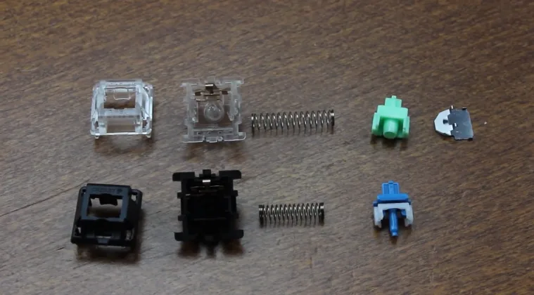 Two disassembled mechanical switches on a table