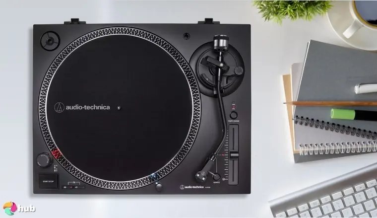 Audio-Technica AT-LP120XUSB-BK Turntable on a white office desk in a top-down view for a review