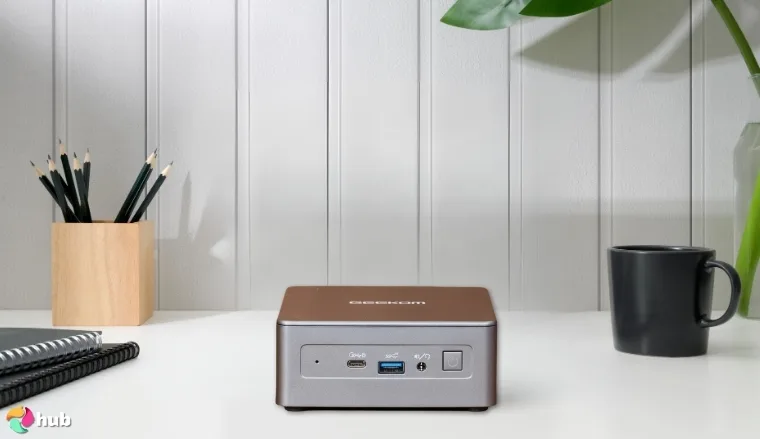 GEEKOM G1 Mini PC on a white office desk with neat arrangement for a review