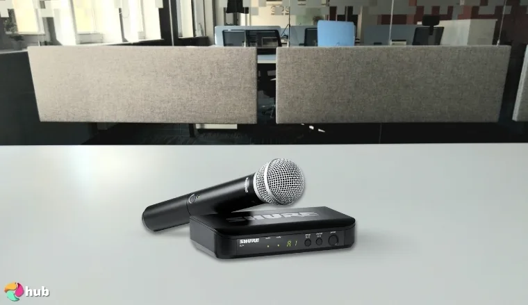 Shure BLX24/PG58 Wireless Microphone on a white office desk in a clean setup for a review