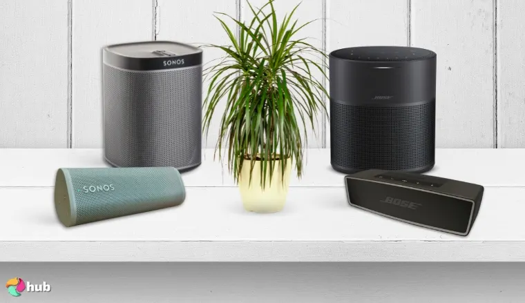Sonos and Bose Speakers on the white desk with a plant between them