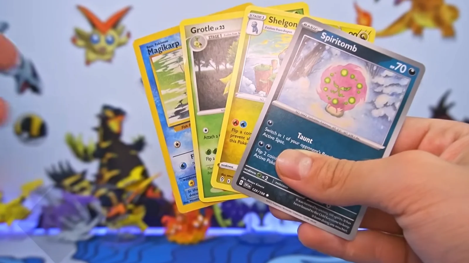 4 Pokemon cards in a hand