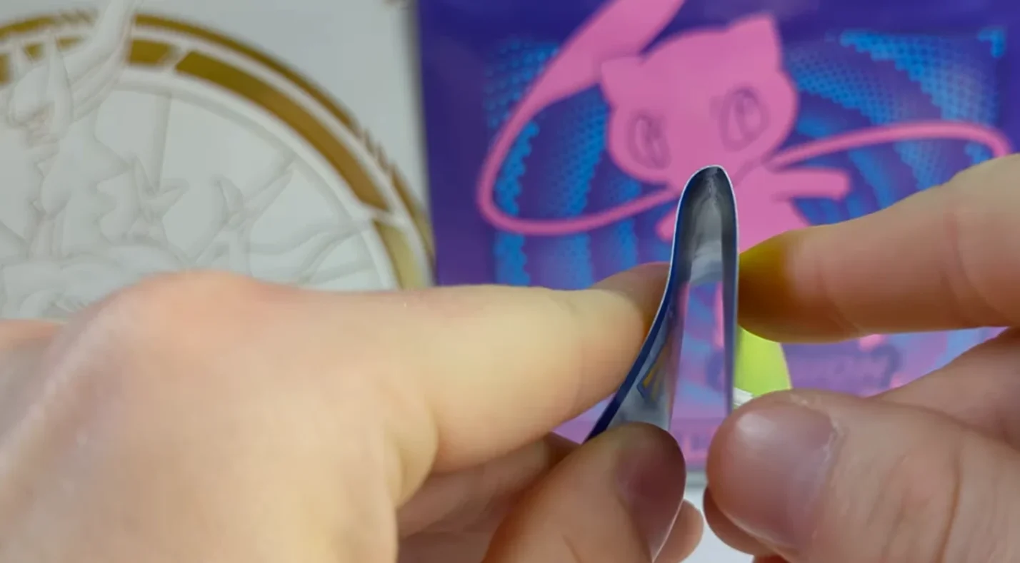 Bended Pokemon card in hands