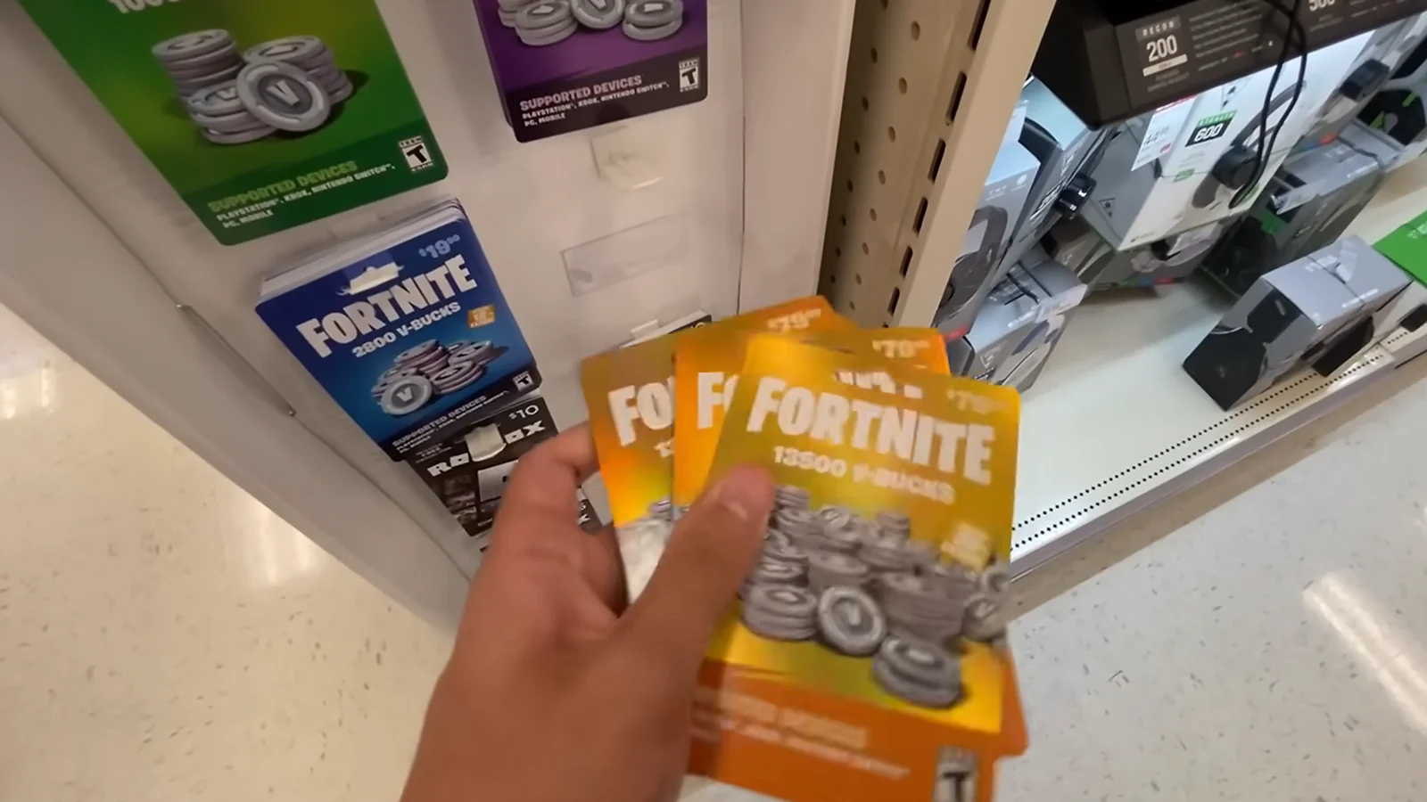 Multiple Fortnite gift cards held in someone’s hands, close-up view