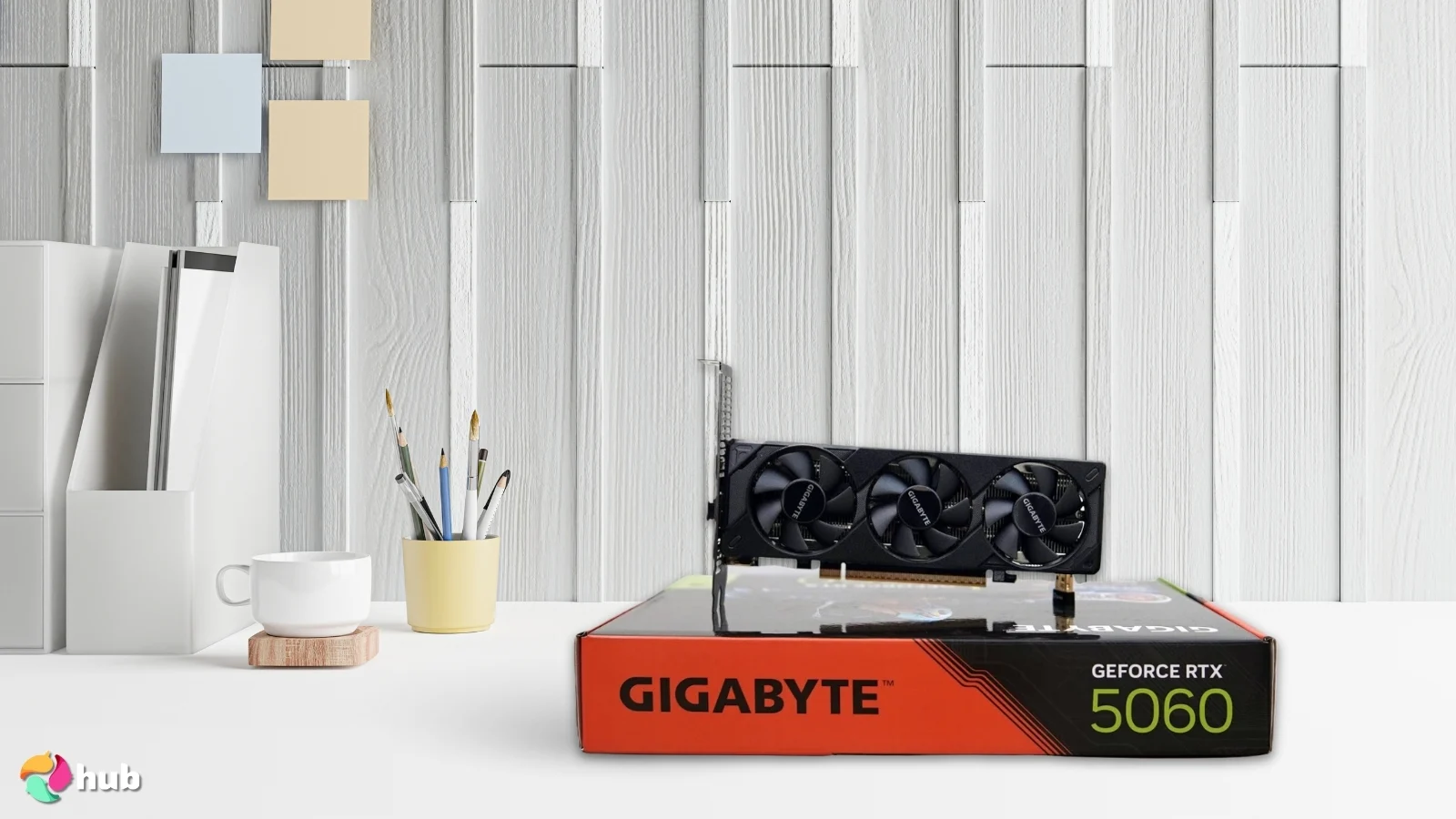 GIGABYTE GeForce RTX 5060 OC Low-Profile GPU on a white office desk in a well-lit setting for a review