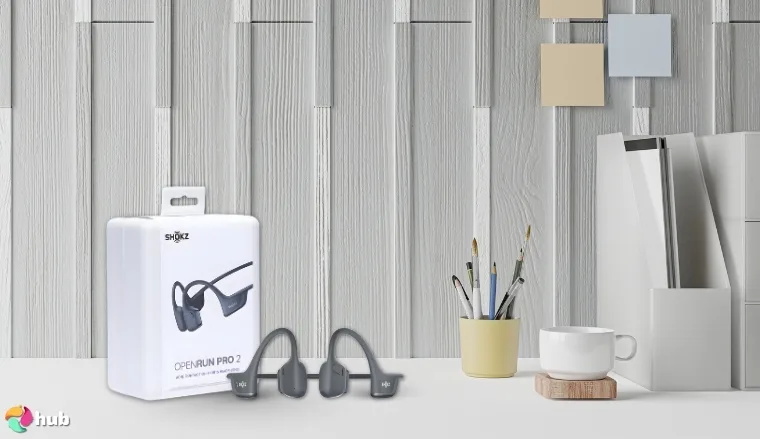 Shokz OpenRun Pro 2 Open-Ear Headphones on a white office desk in a clean setup for a review