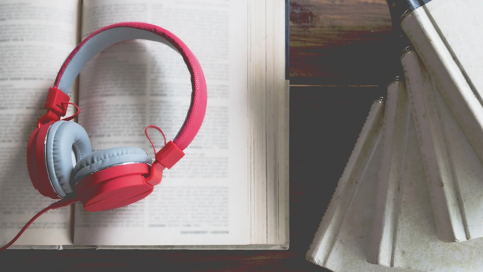 Headphones lying on an open book