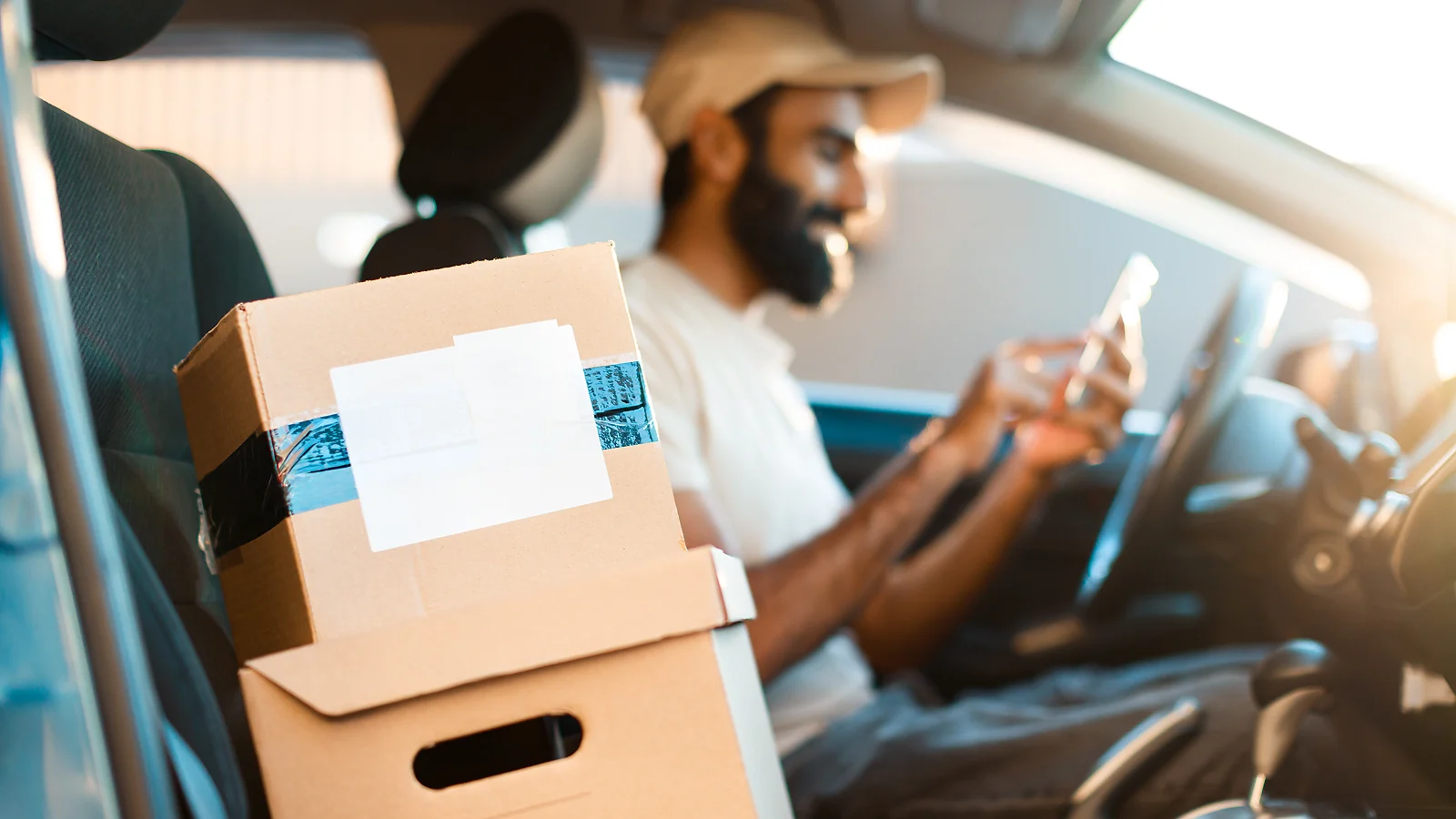 A man with boxes in the car