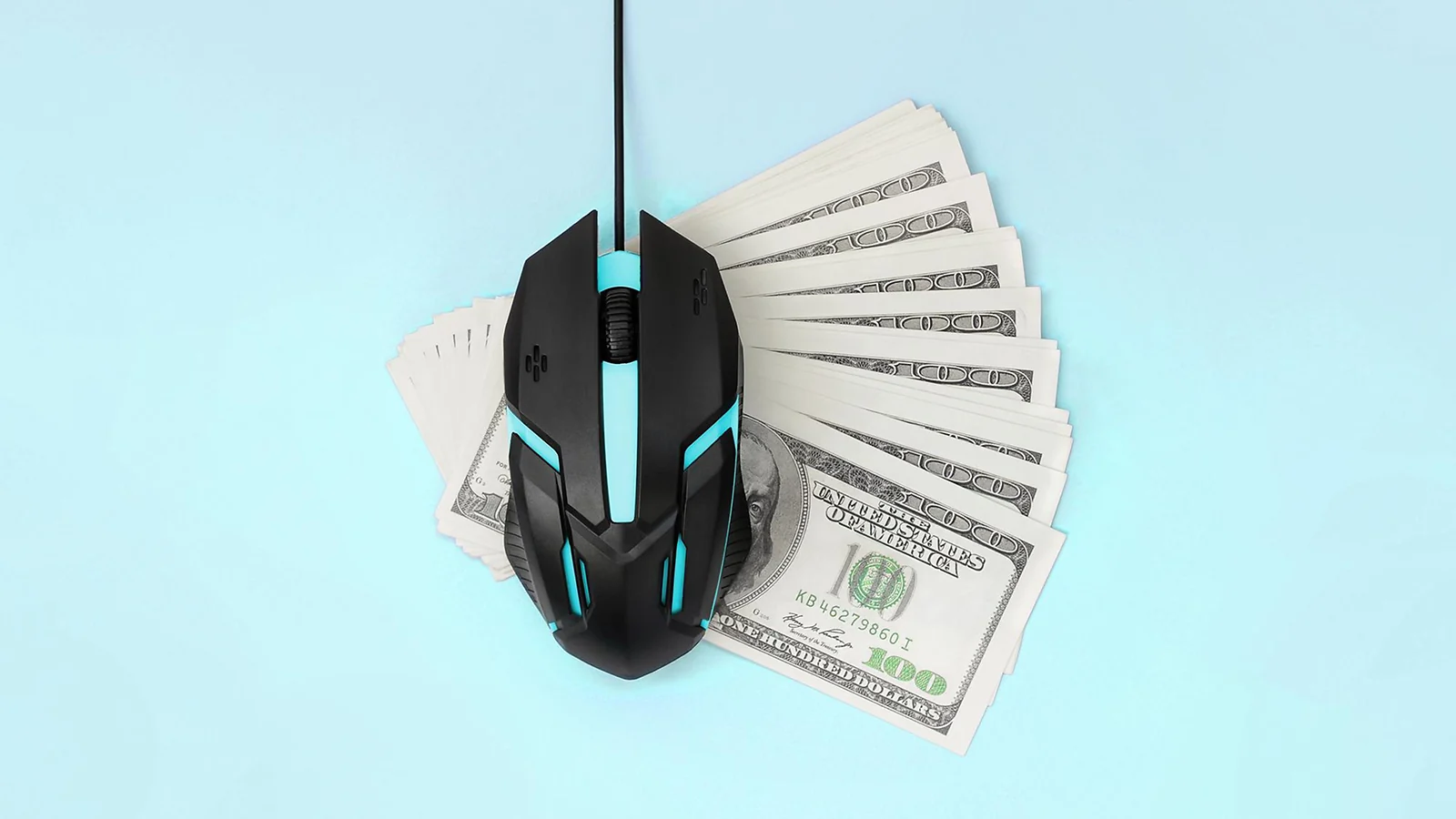 Computer mouse next to dollar bills