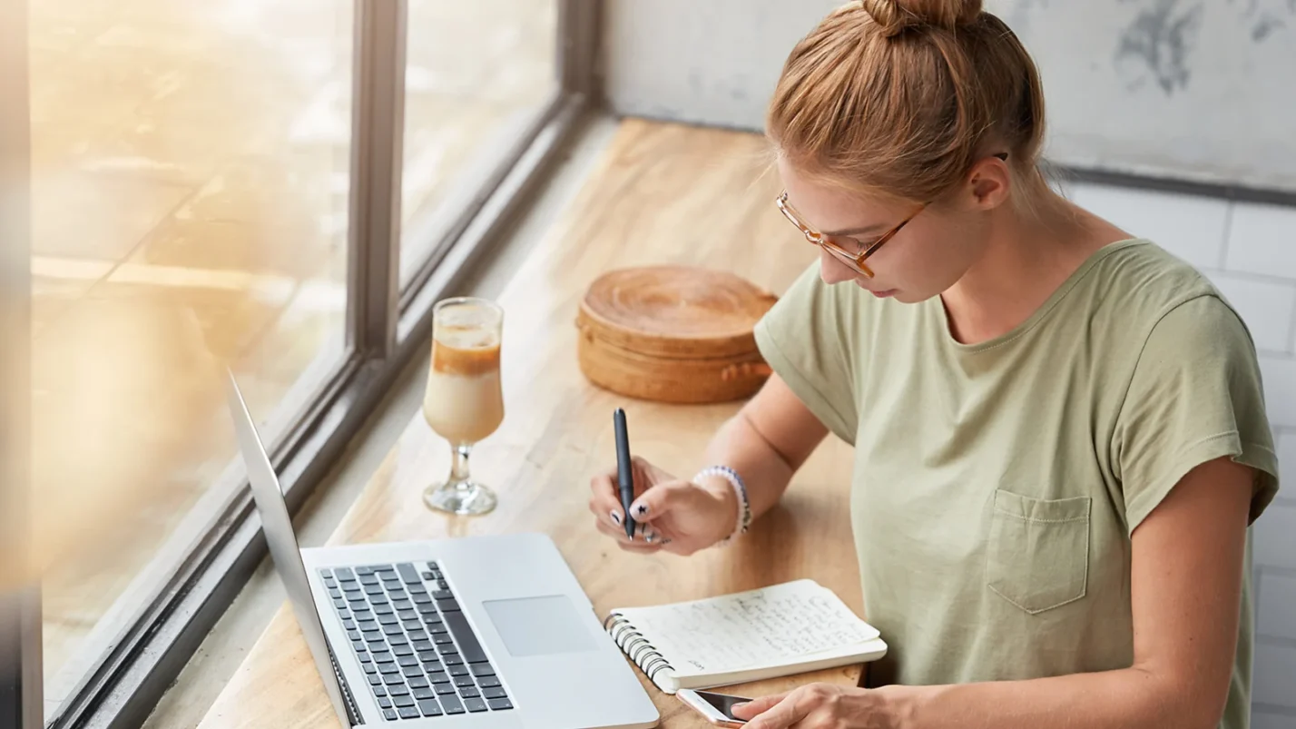 woman is sitting and writting