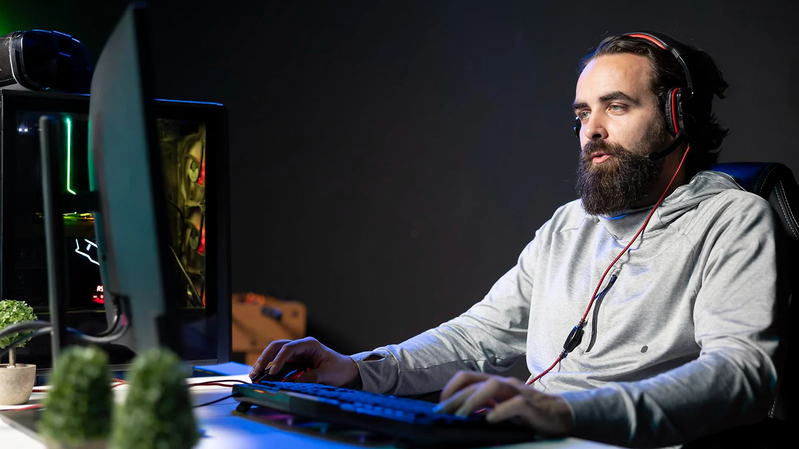 A man with headphones working on PC