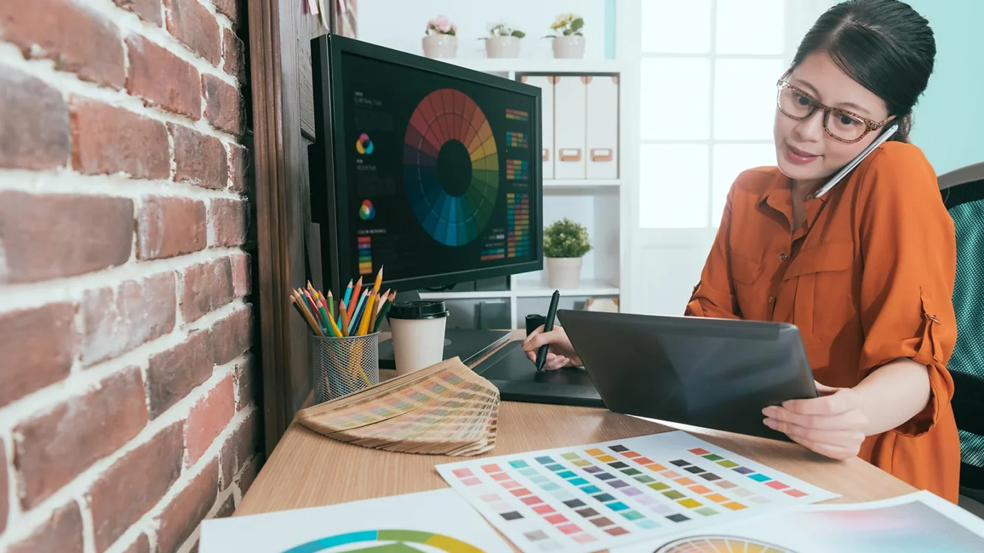 woman is on the phone in front of the computer