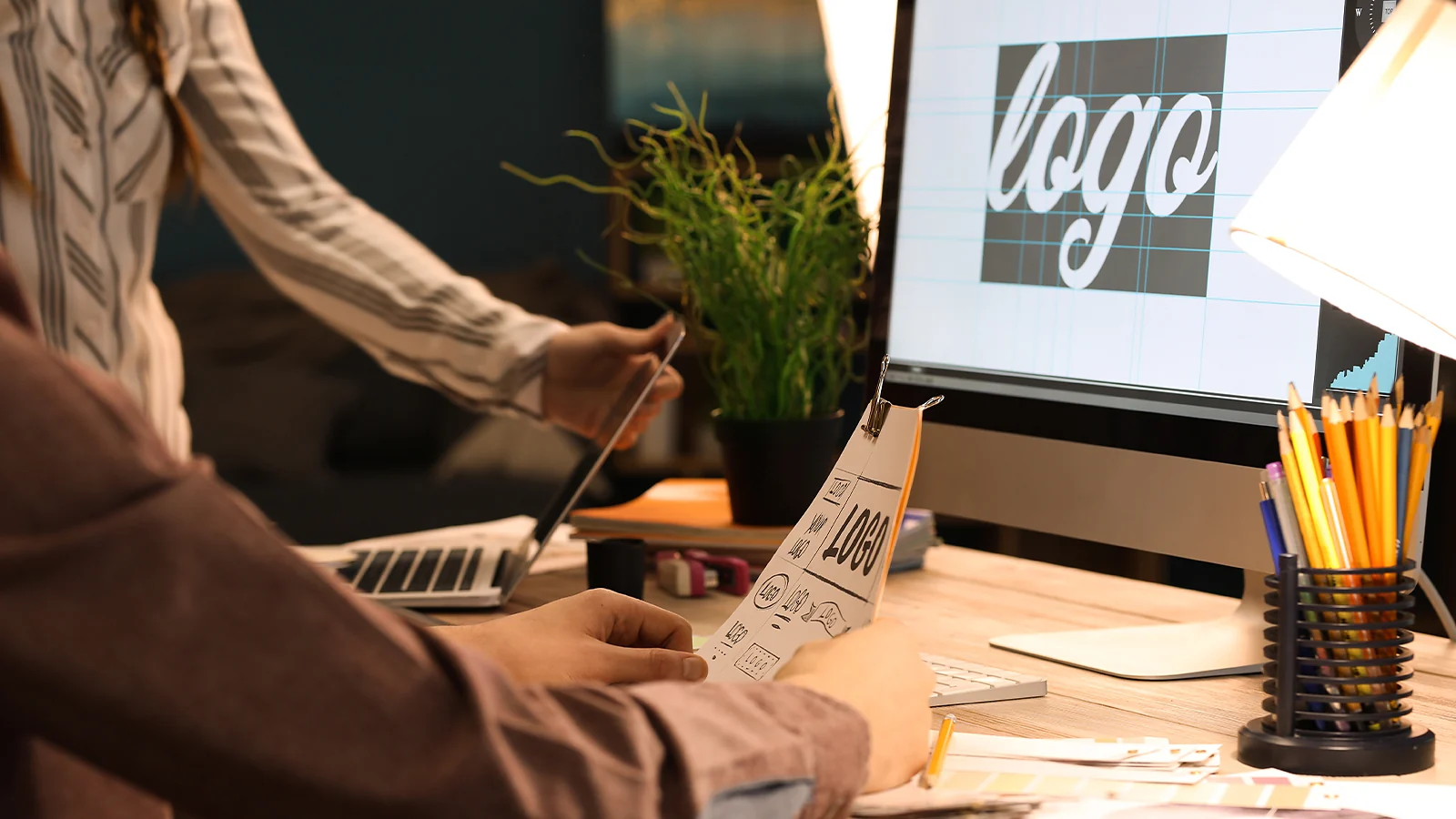 Graphic designer reviewing a hand-drawn logo sketch