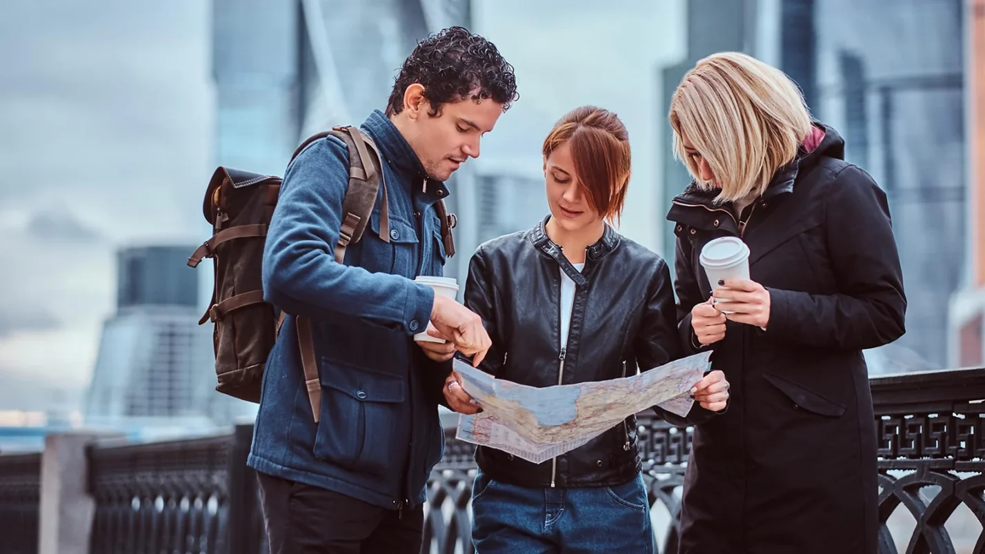 three people looking at the map