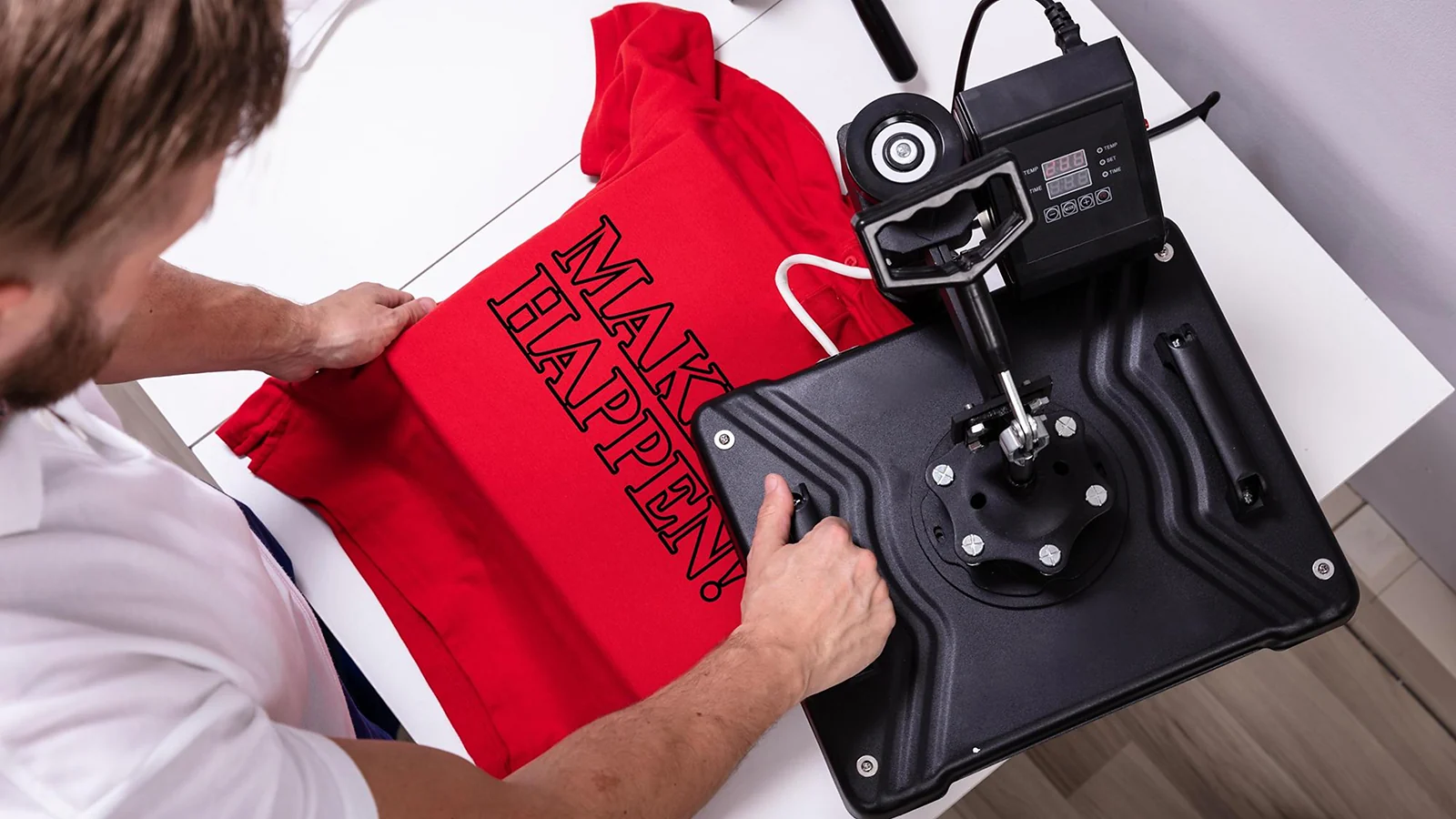 A man printing a t-shirt