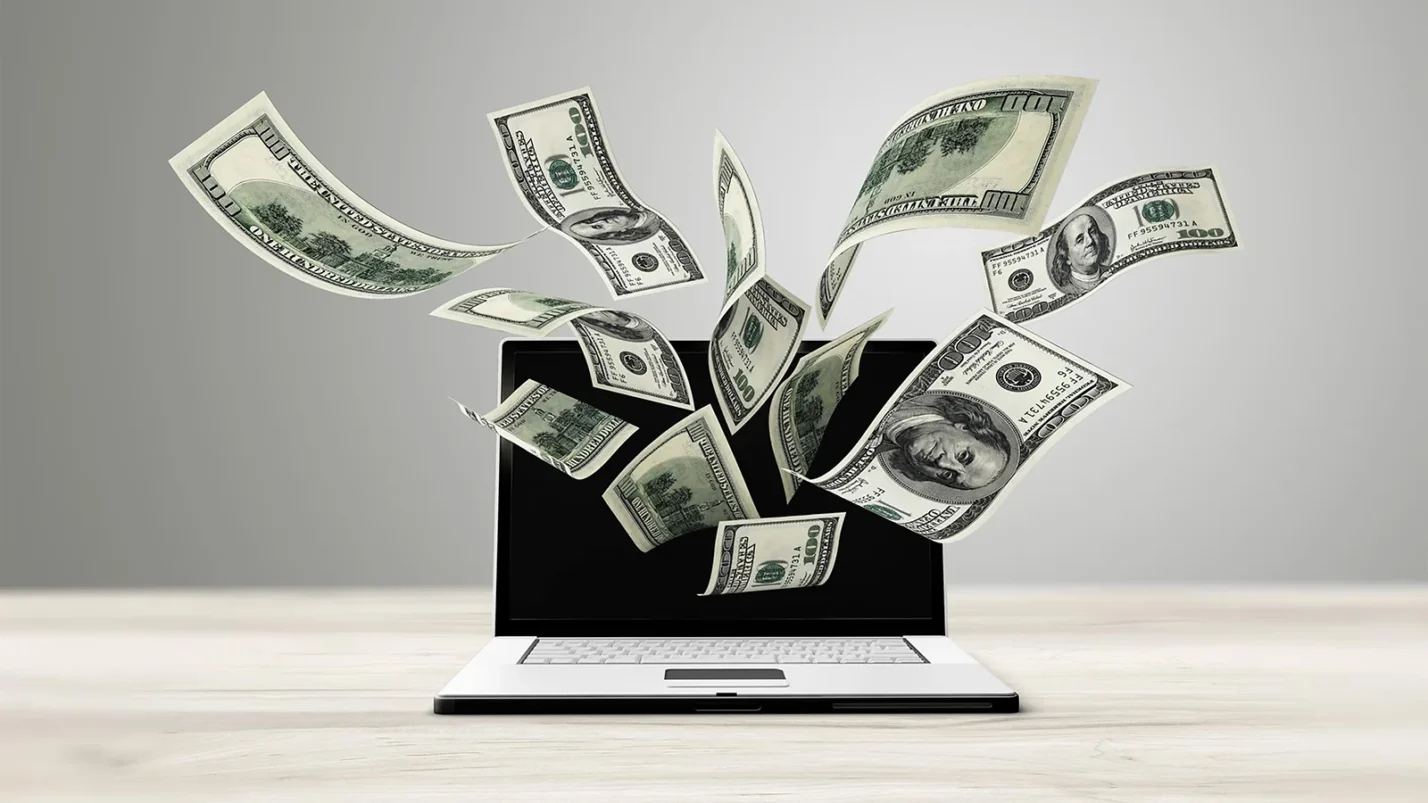 dollars fly out of the laptop