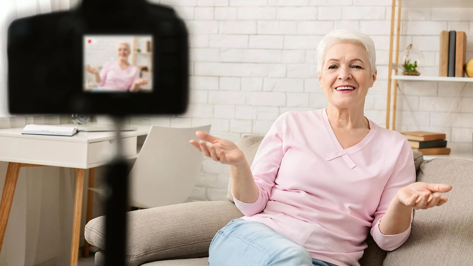 A smiling woman sitting in front of camera