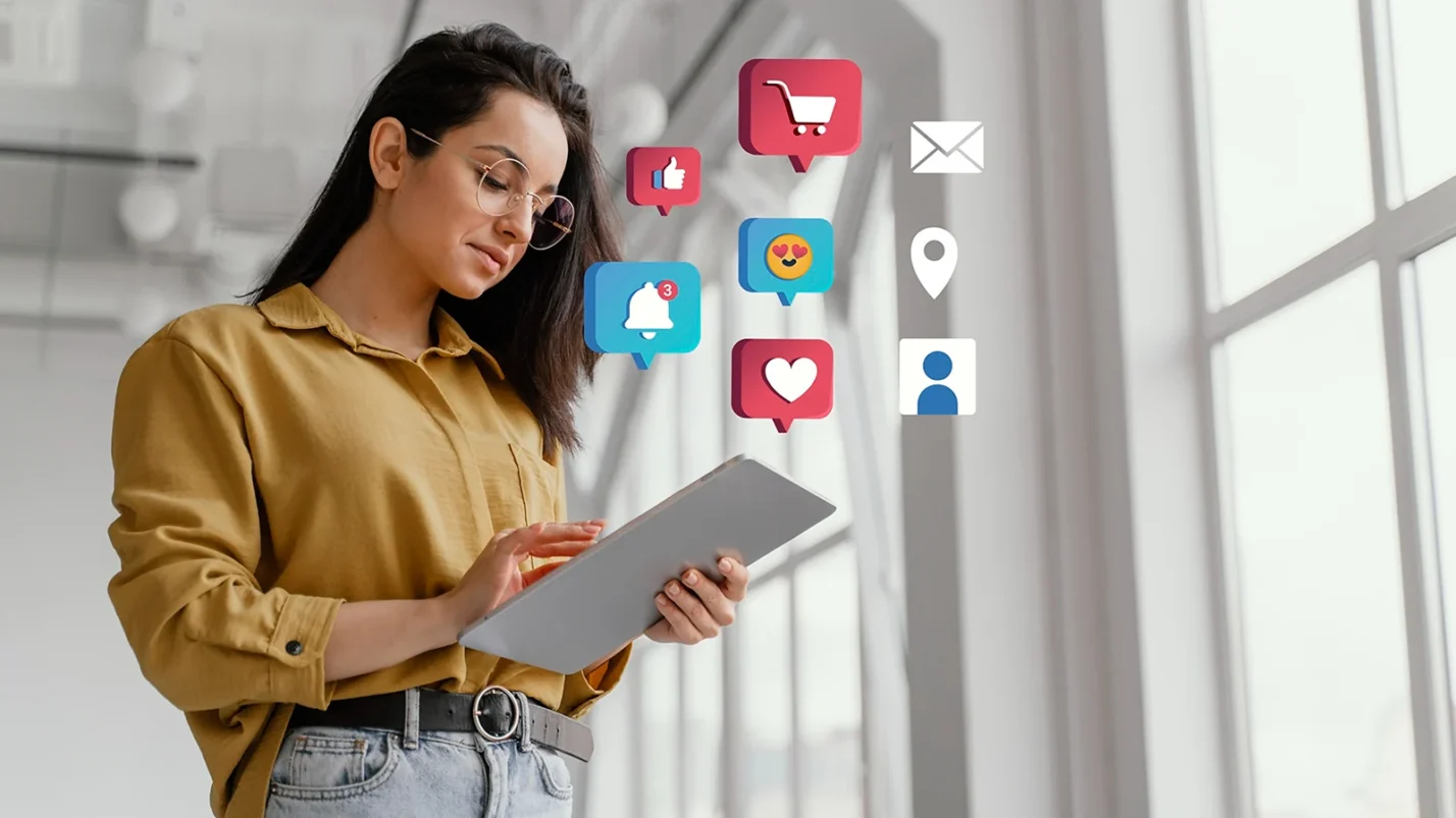 woman lookint at tablet and 3D icons around her