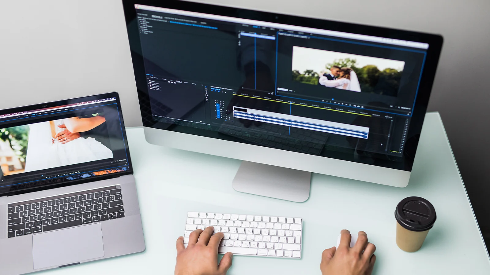 Person editing wedding footage on an iMac and MacBook Pro using professional video software