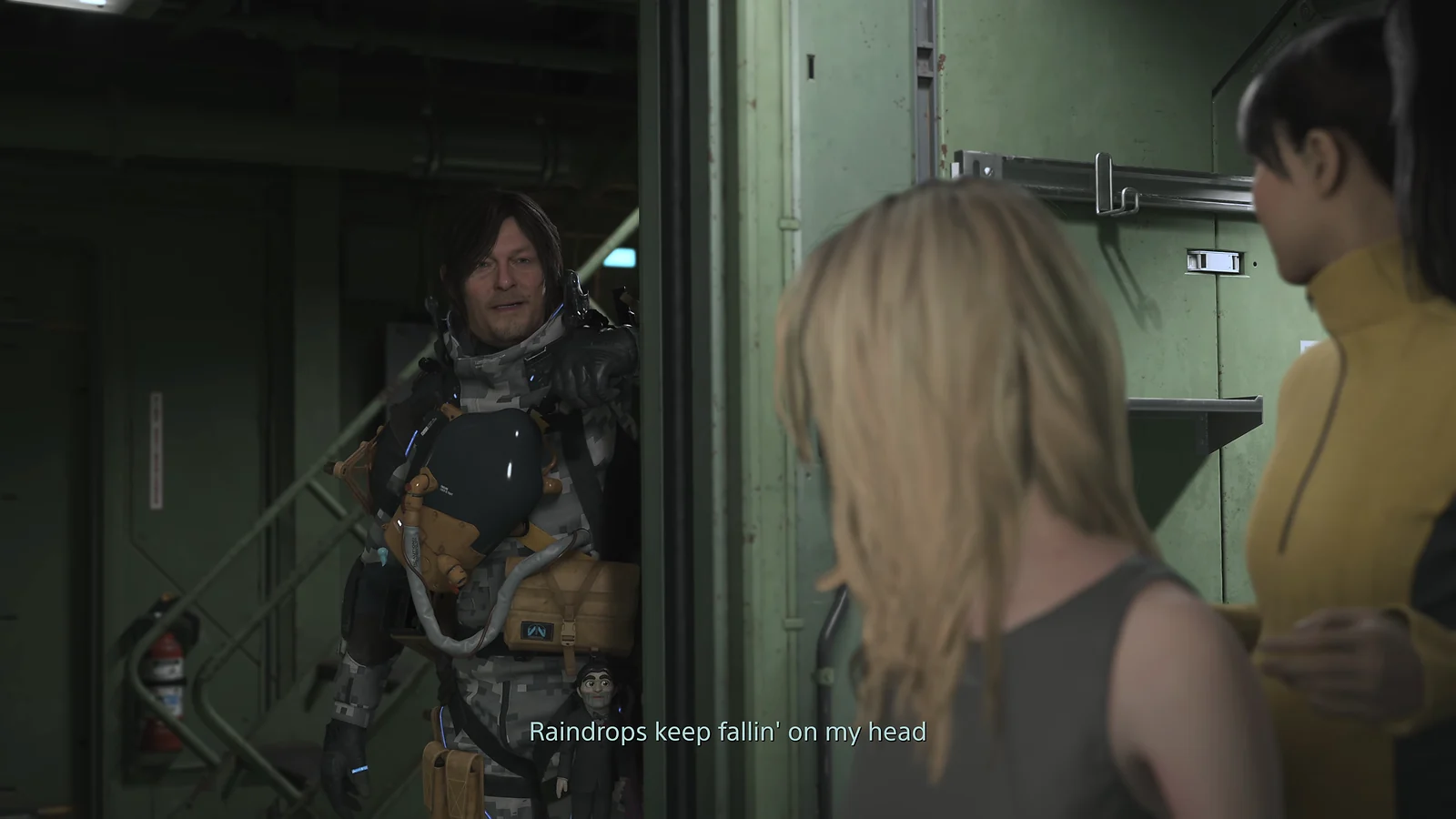 Sam standing in a doorway singing 'Raindrops keep fallin' on my head' to other characters