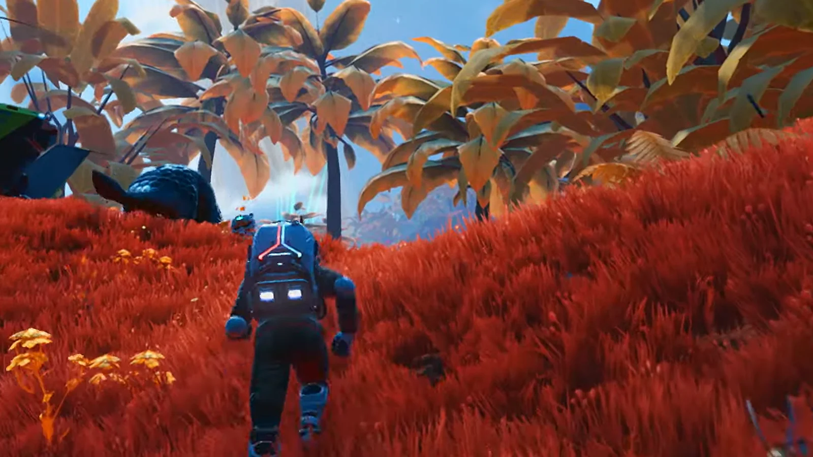 No Man's Sky gameplay screenshot of a player exploring a red alien planet