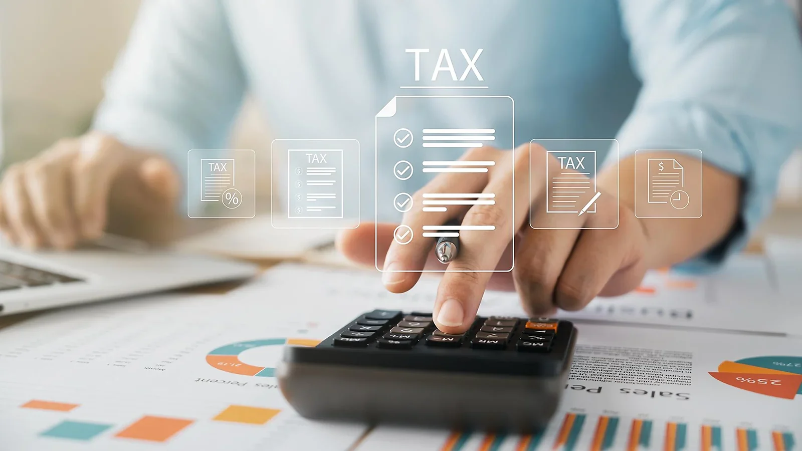 Declaración de la renta: Manos utilizando una calculadora sobre gráficos financieros con documentos fiscales digitales superpuestos