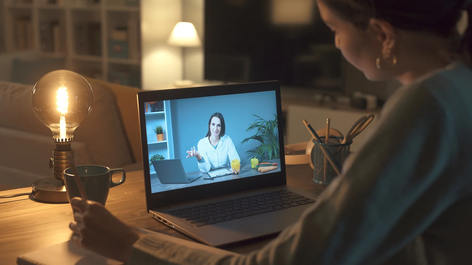 Online course: Watching a pre-recorded online dietician course on a laptop