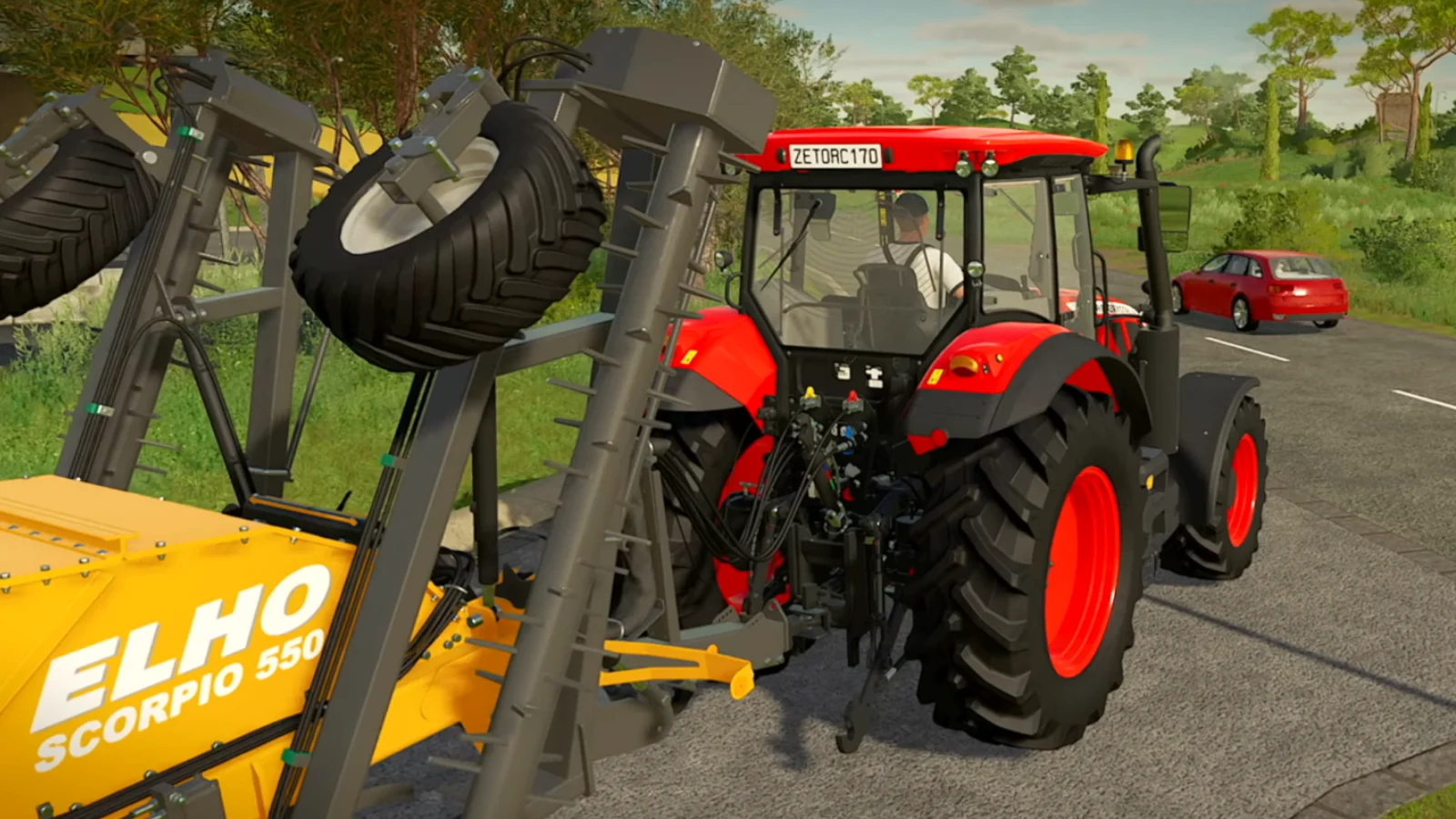 Red tractor towing farming equipment down a countryside road in Farming Simulator 22