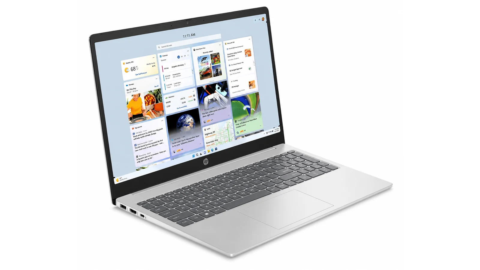 HP Laptop 15 open at a three-quarter angle on white background showing Windows 11 widget tiles on screen