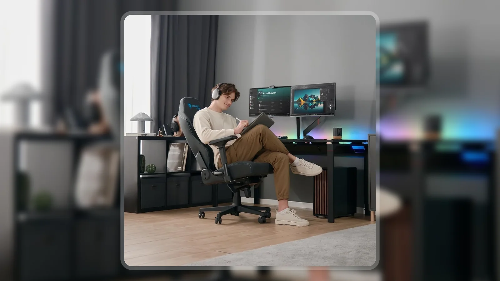 Man sitting in Secretlab Titan Evo Lite chair at gaming desk with dual monitors and RGB lighting