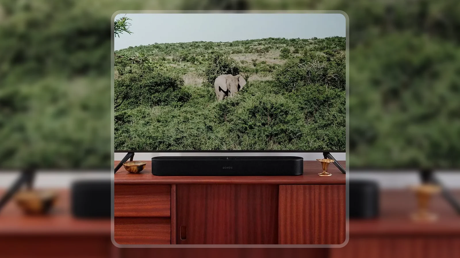 Sonos Beam Gen 2 soundbar on a wooden media cabinet below a large TV in a living room