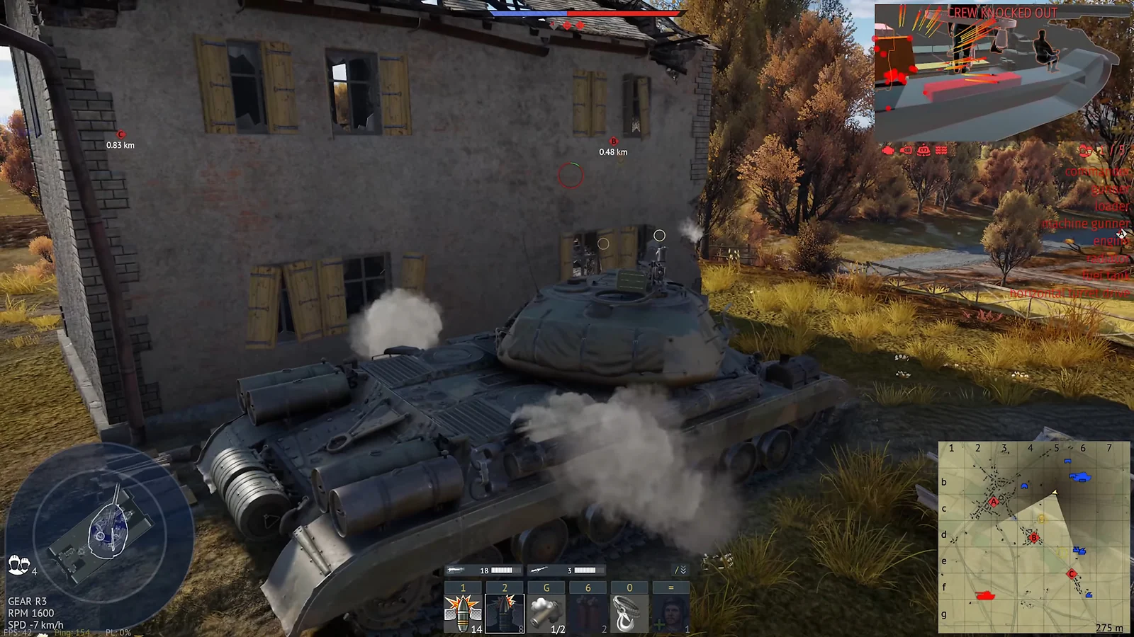 Green tank taking damage next to a ruined building with smoke billowing from its side