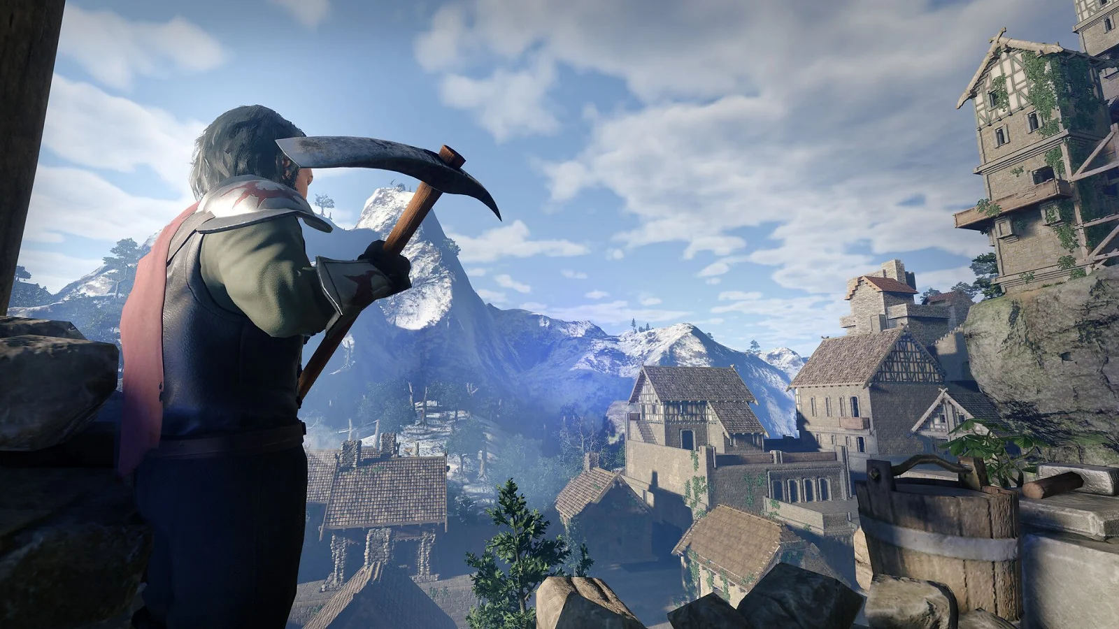 A character holding a pickaxe overlooks a medieval mountain village surrounded by snowy peaks.