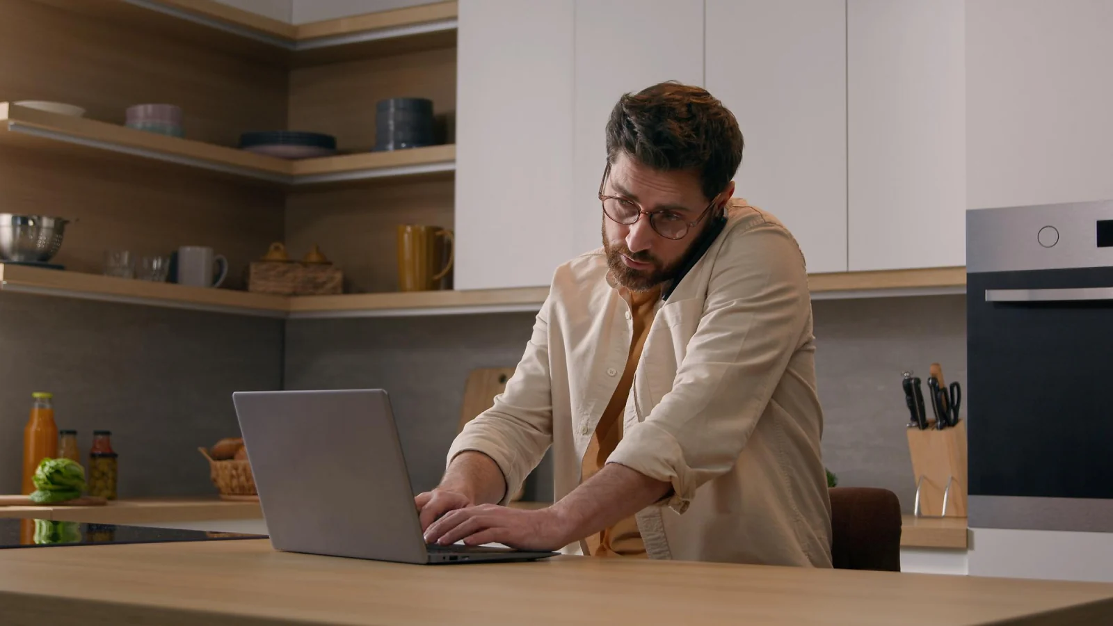 person working on a side hustle at a kitchen table in the evening after a full-time job