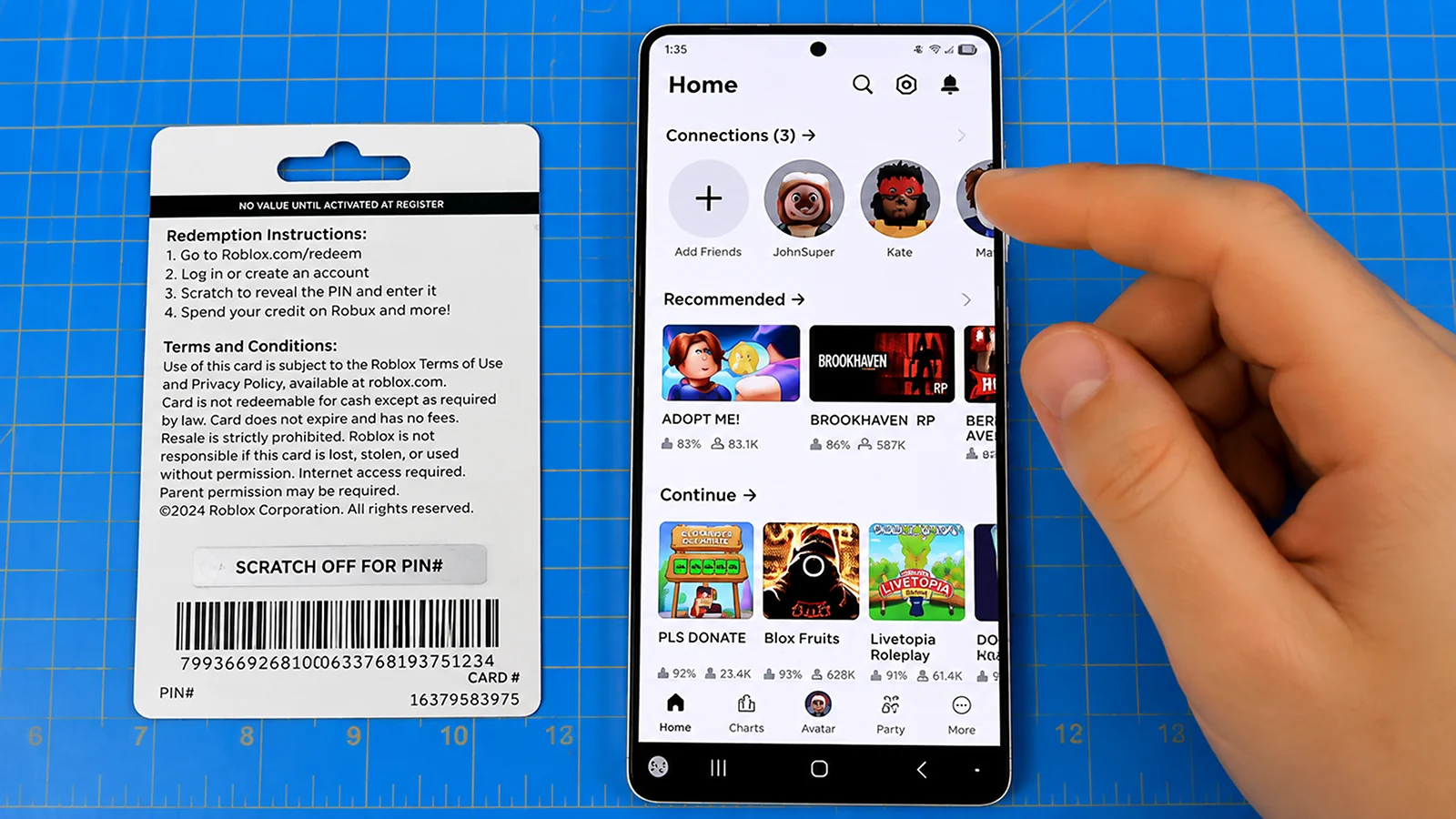 Robux - A hand scrolling on a phone with the Roblox app open on the screen
