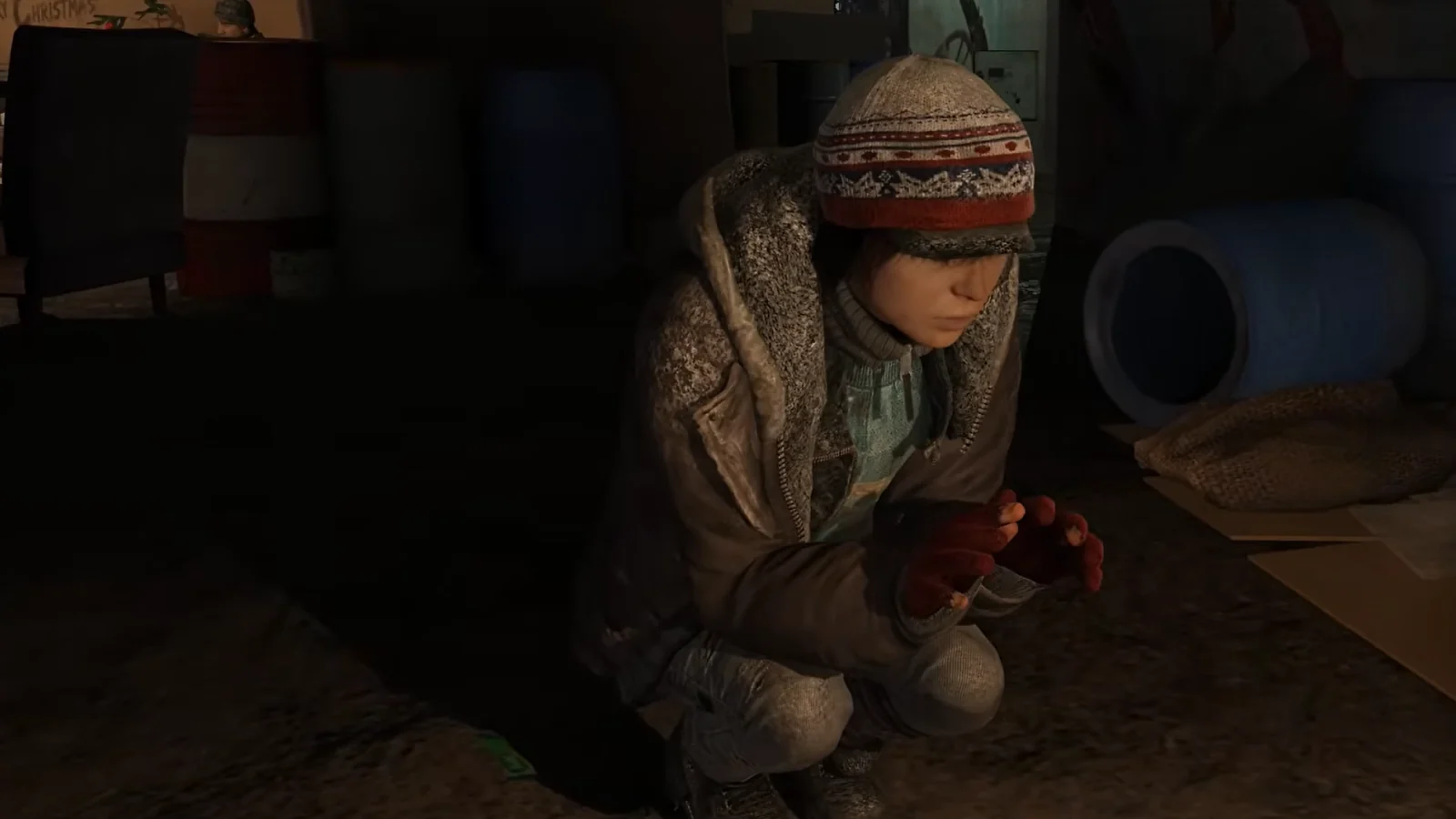 Beyond: Two Souls gameplay showing Jodie sitting alone in a dimly lit room