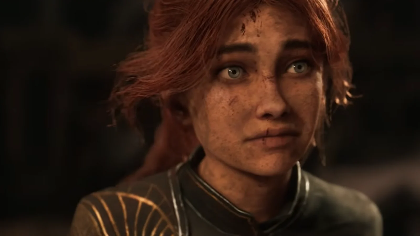 Close-up of a freckled, red-haired woman looking upward.
