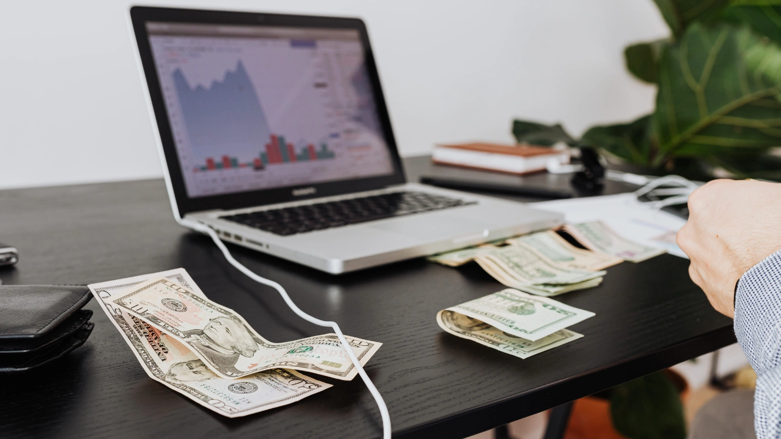 Person checking a monthly budget while researching how to make cash online