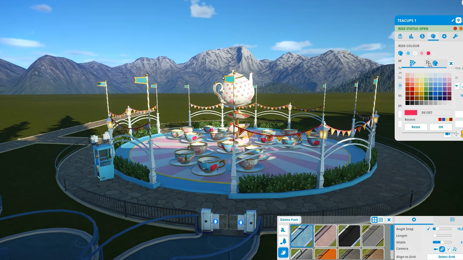 Planet Coaster gameplay showing a colorful teacup ride being customized in a theme park