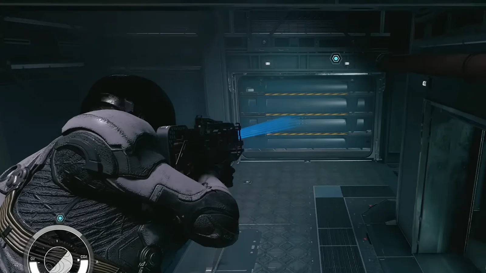 An astronaut explores a dark, futuristic facility.