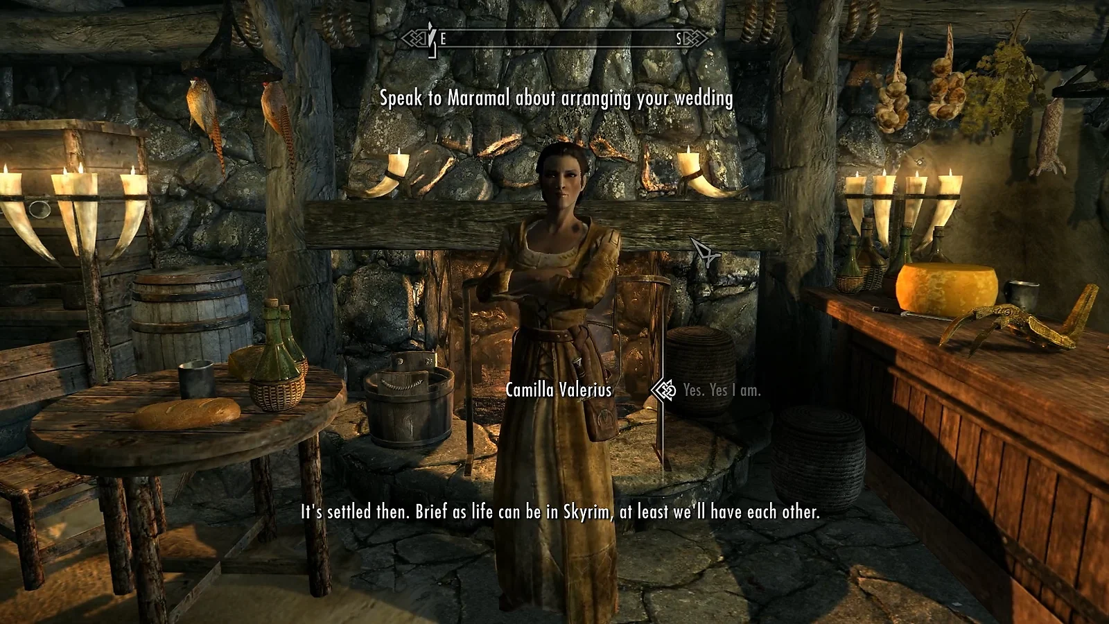 The Elder Scrolls gameplay showing a dialogue scene inside a medieval tavern.