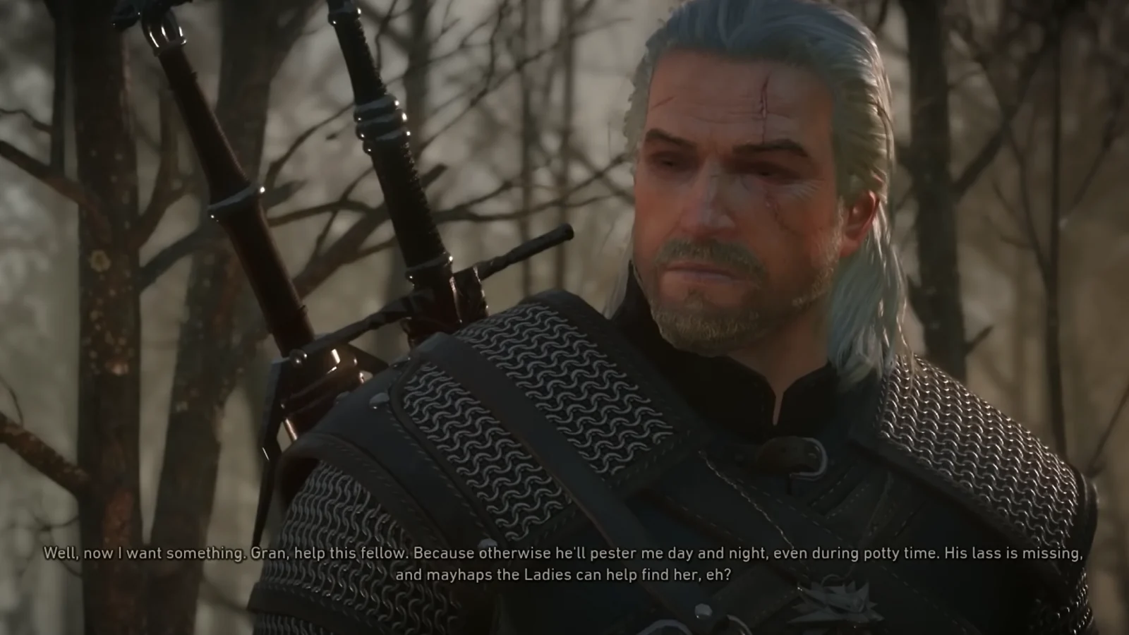 Geralt stands in a forest with swords strapped to his back.