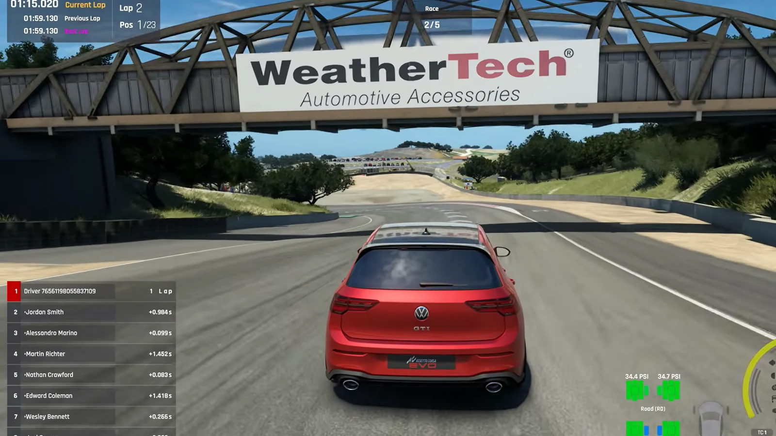 A red sports car races beneath a WeatherTech bridge. .
