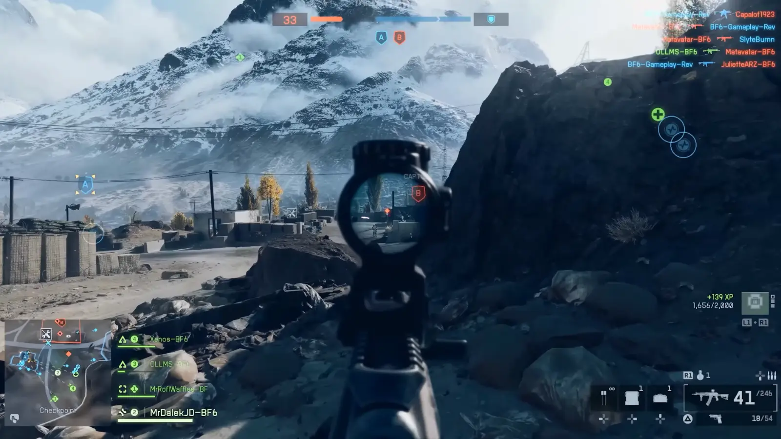 First-person view of a soldier aiming toward enemies across a snowy mountainous battlefield