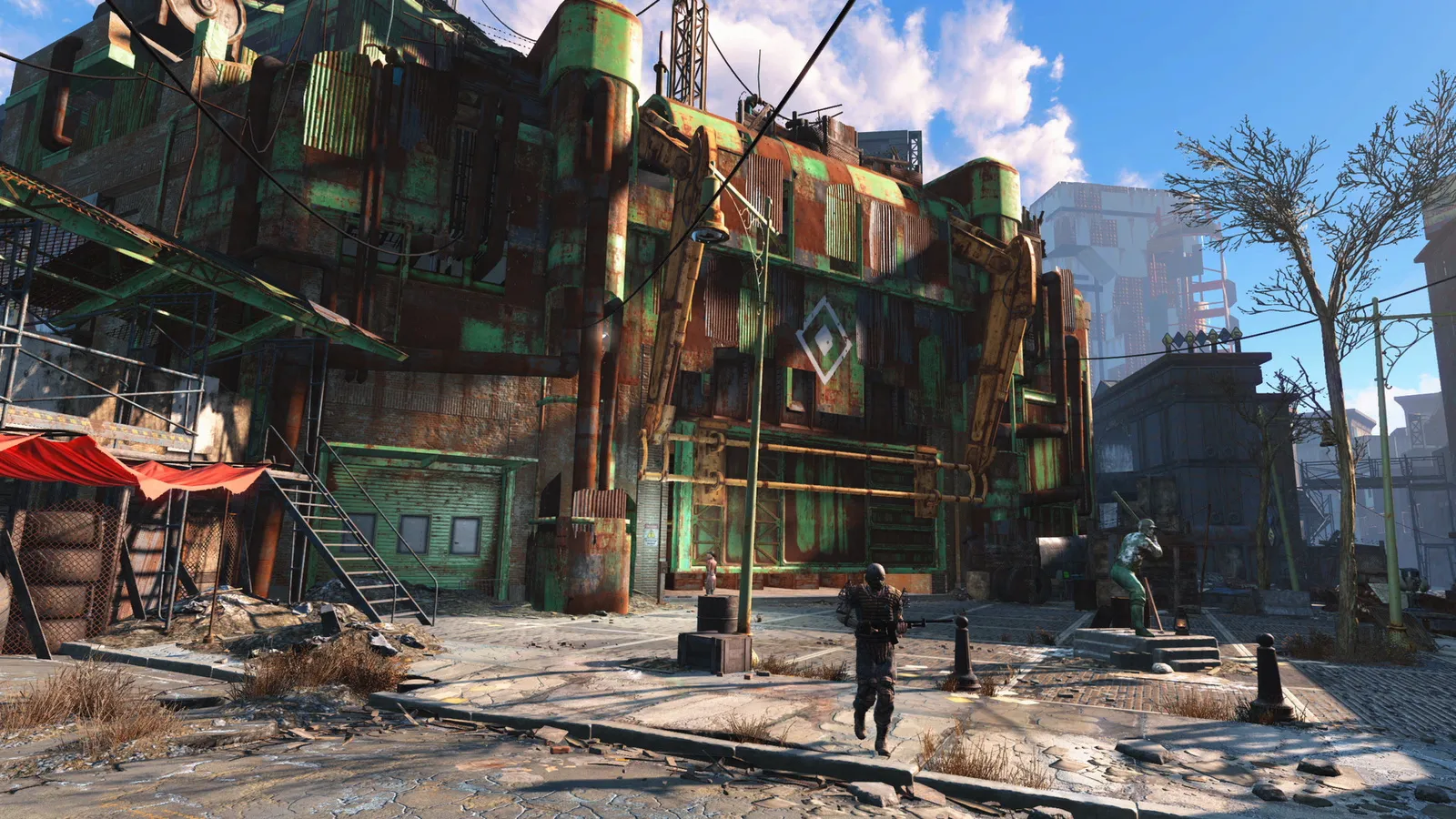 Fallout 4 (GOTY) rusted factory building with armed survivor and statue