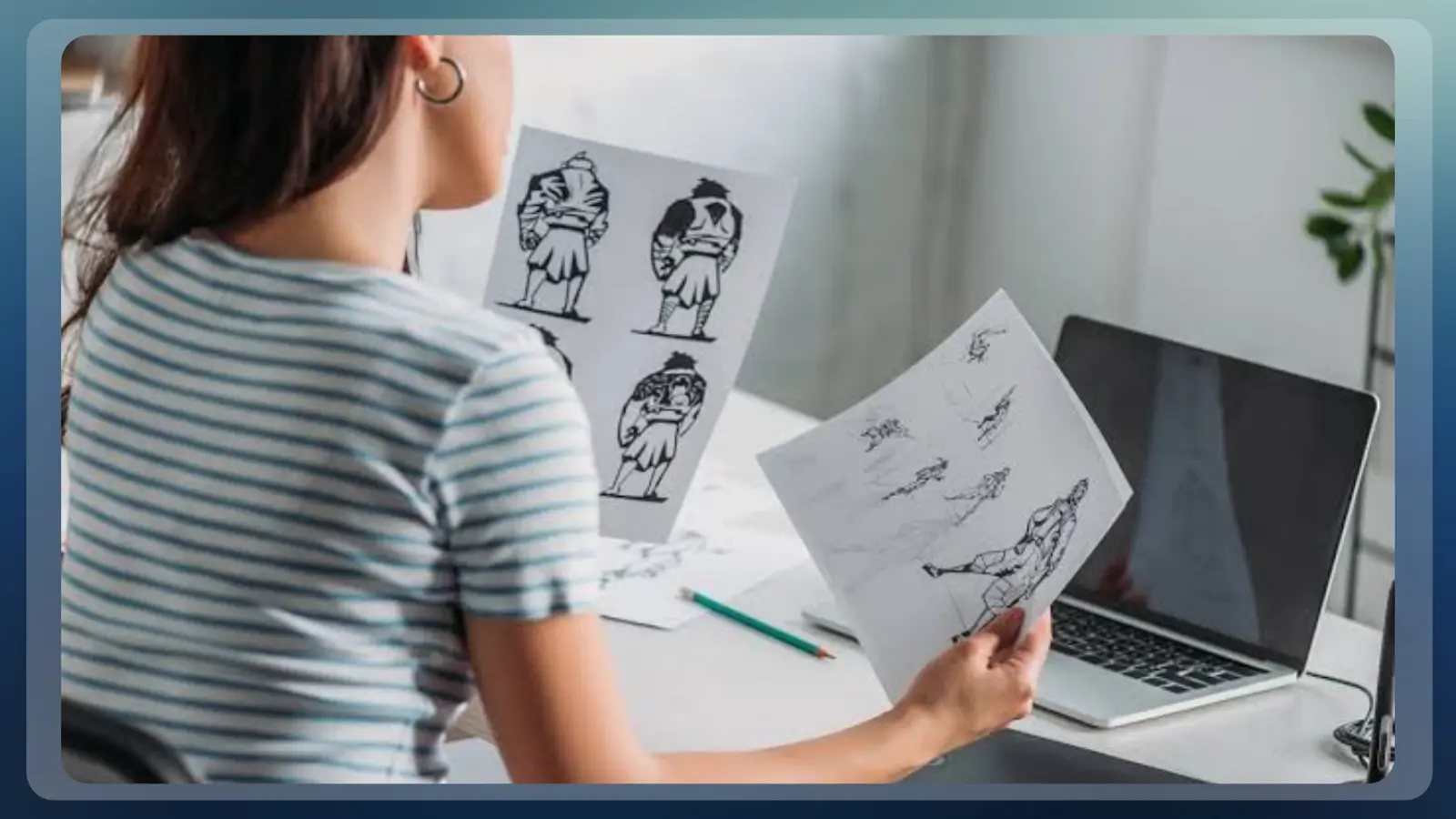 Concept artist reviewing a game character design sheet beside environment studies