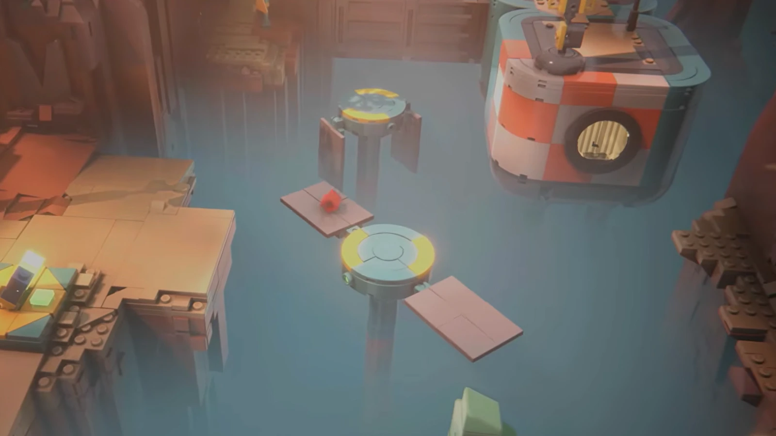 A tiny red brick crosses a rotating bridge puzzle above misty blue water between brick-built cliffs